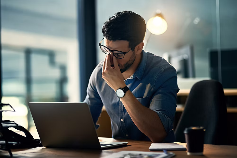 Tired man with laptop