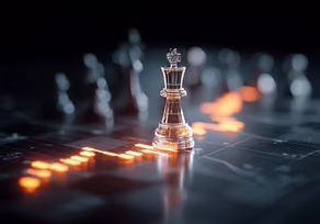 A glass king chess piece glowing on a dark board.
