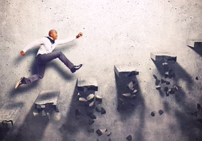 Businessman leaping across gaps